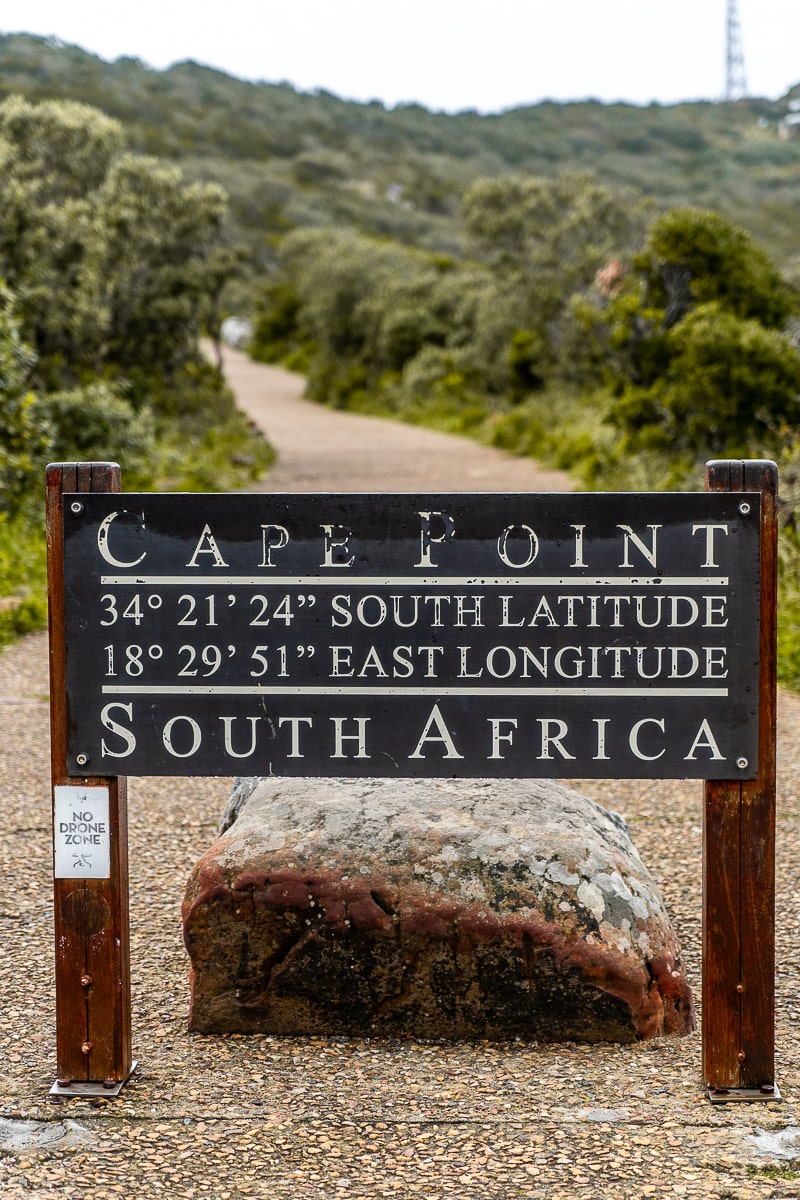 A wooden sign reading "Cape Point South Africa" and it's latitude and longitude coordinates