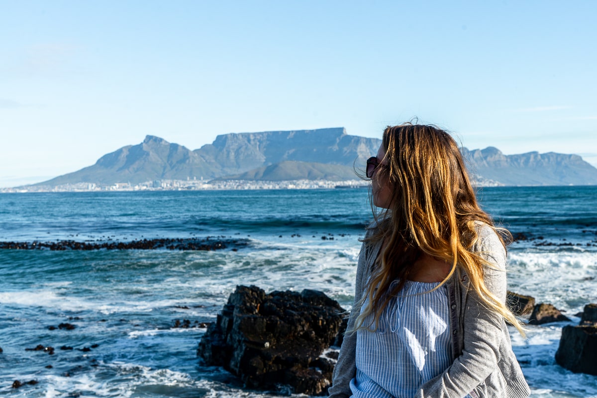 A woman gazing towards Cape Town from the distant shore of Robben Island