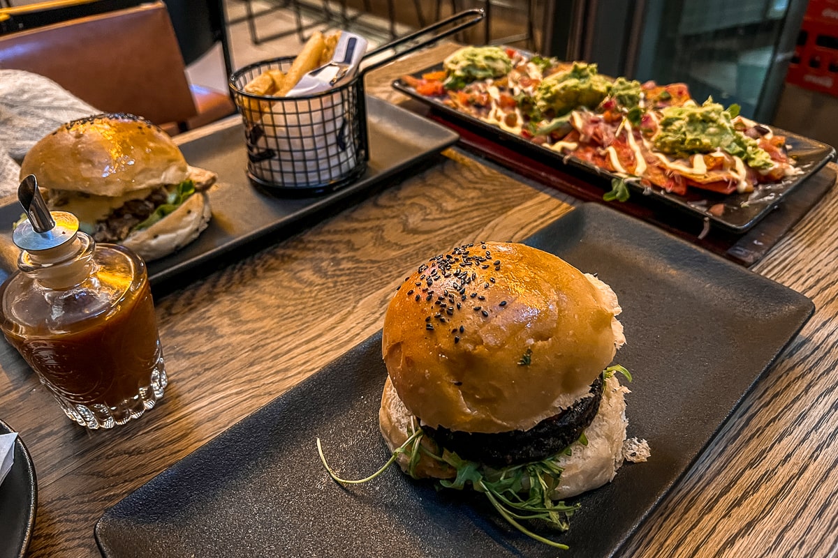 Two gourmet burgers, dirty fries and drinks