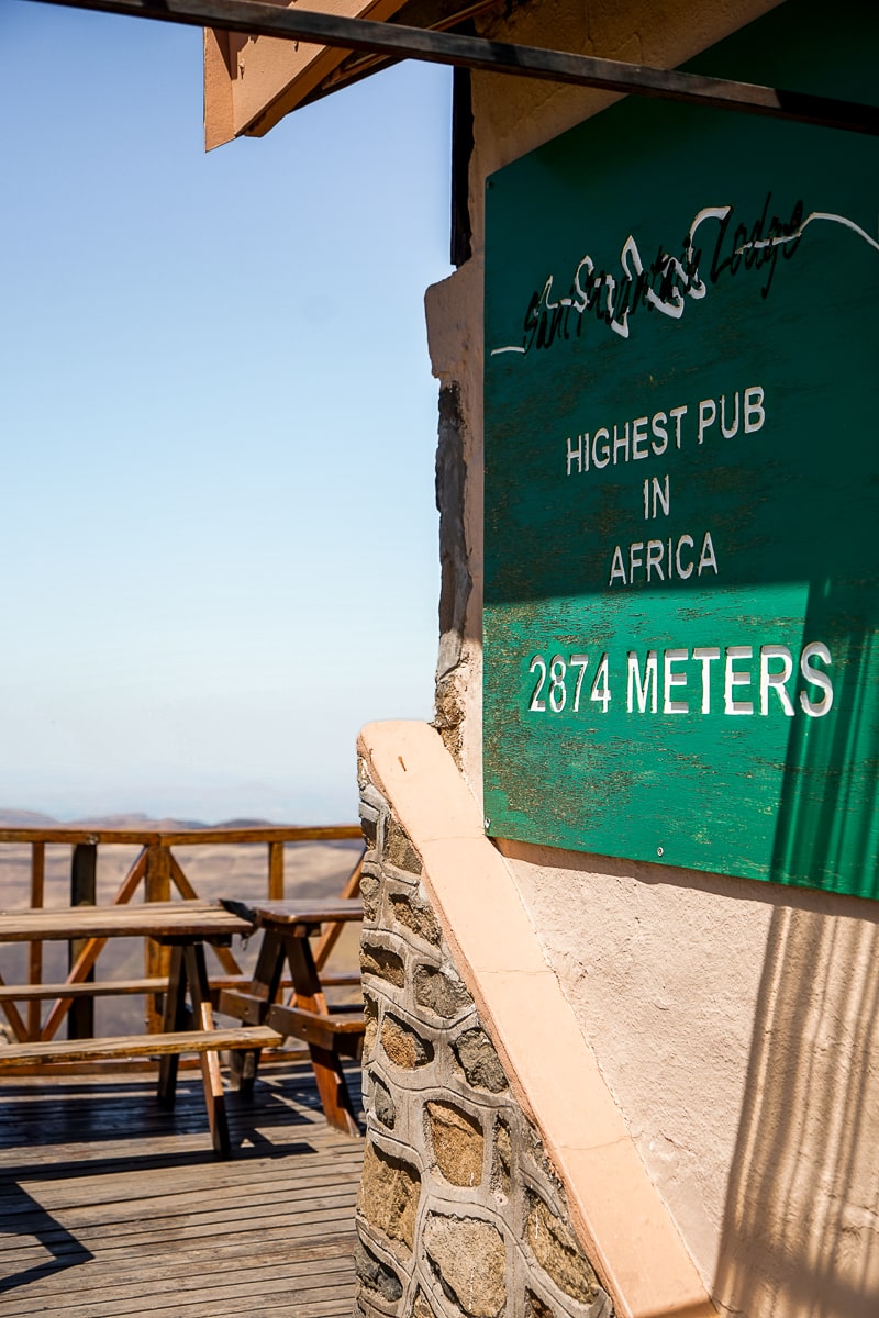 A sign on a building reading "Highest pub in Africa - 2874 meters"