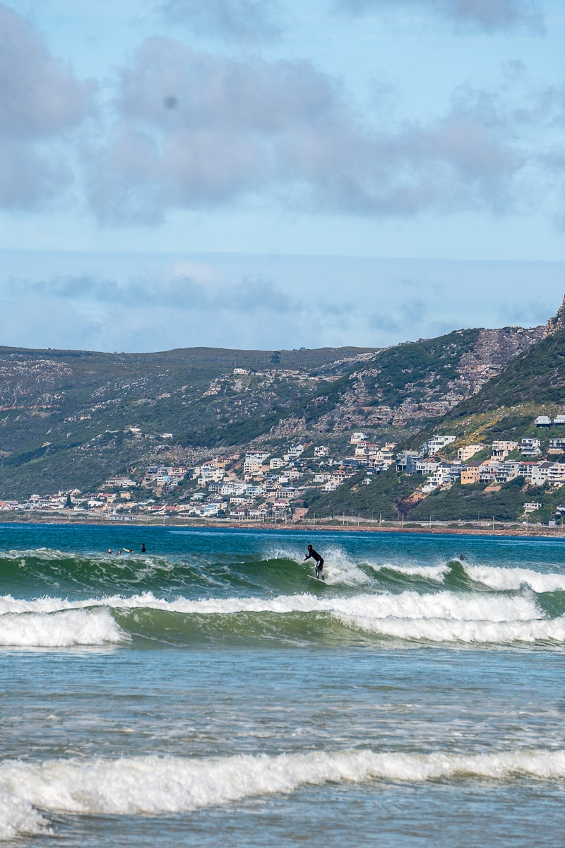 Surfers taking on a big wave in a choppy sea
