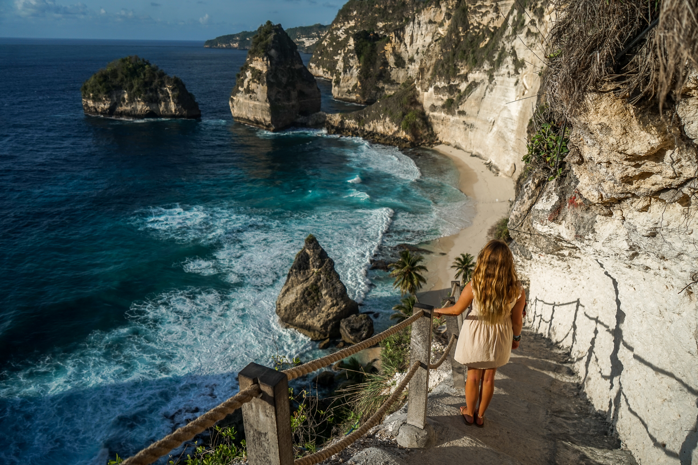 A woman stood on the steps leading down to Diamond Beach in Nusa Penida
