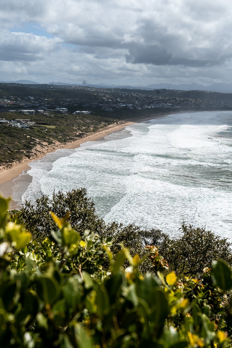 A long sandy bay with foamy sea