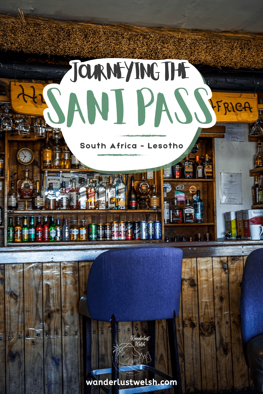 A pub with a wooden bar and a wide selection of beers and spirits with the words "Journeying the Sani Pass" superimposed