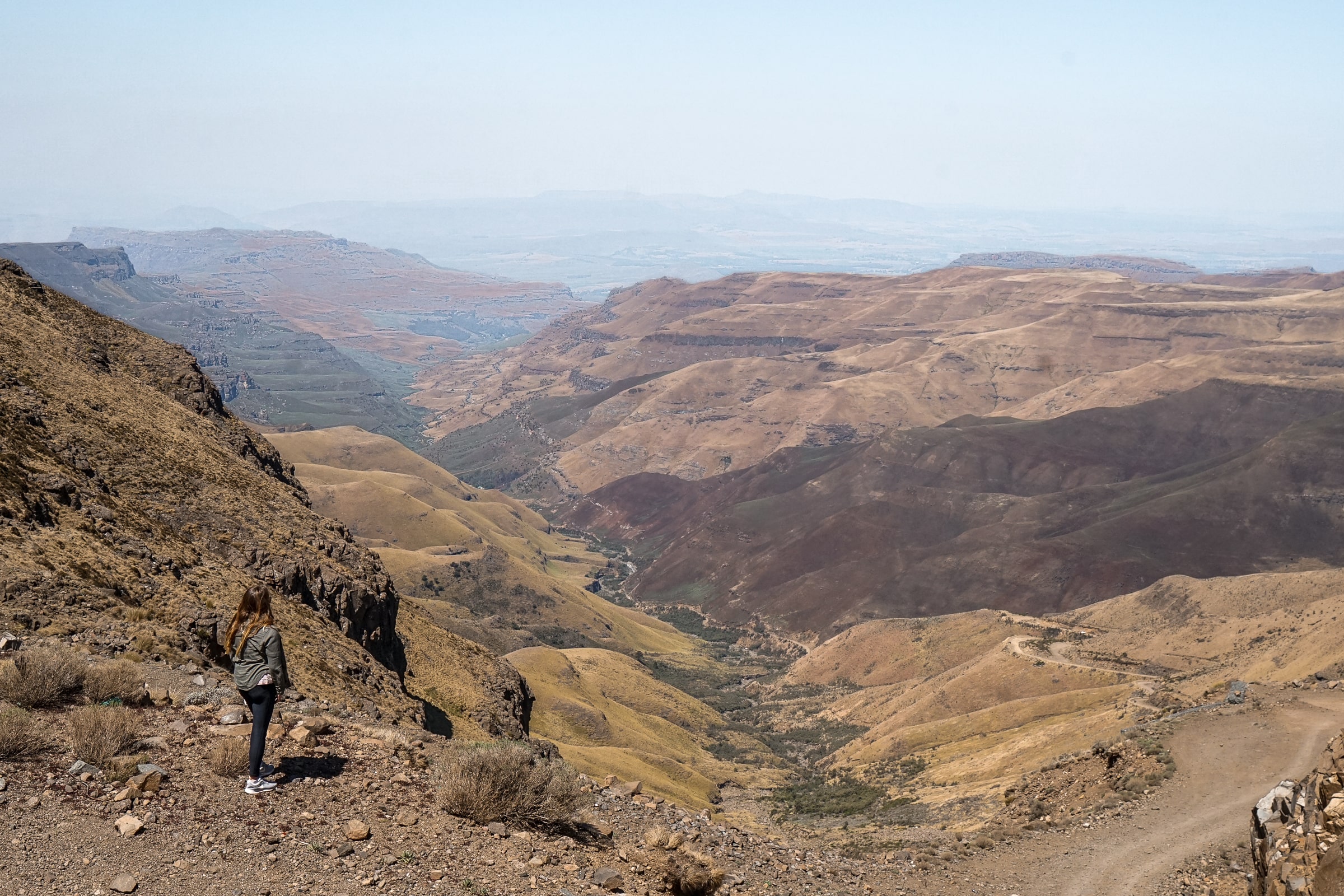 A woman enjoying the viewpoint of the rocky Sani Pass