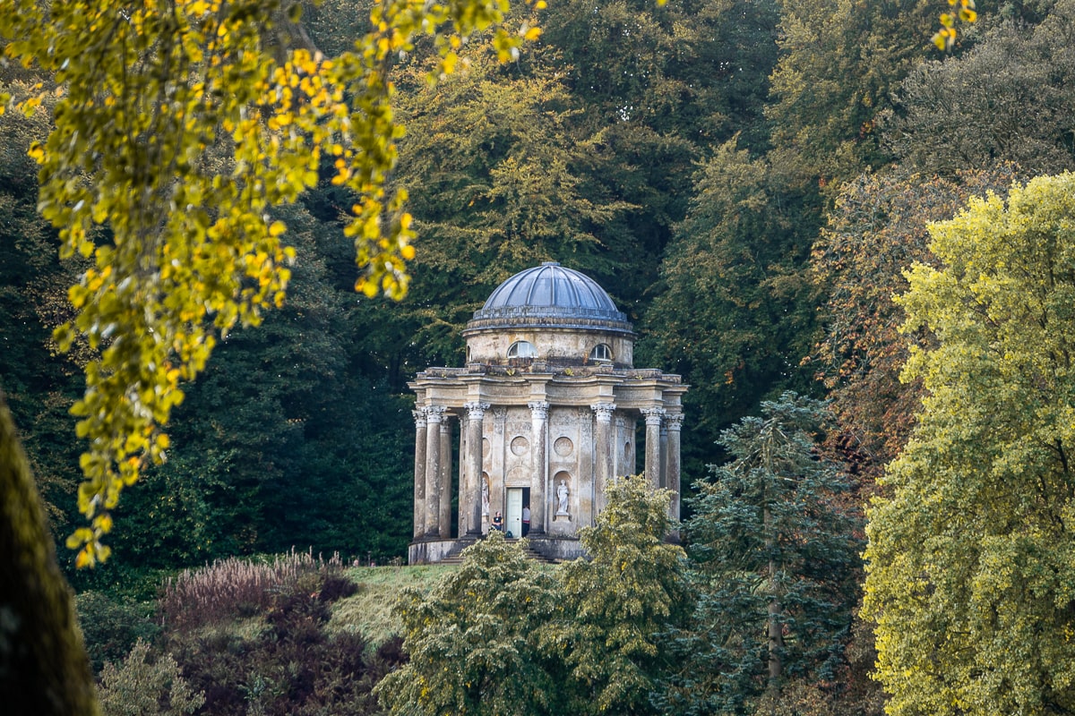 A neoclassical temple surrounded by trees