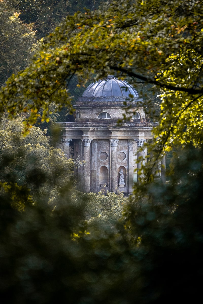 A neoclassical temple framed by trees