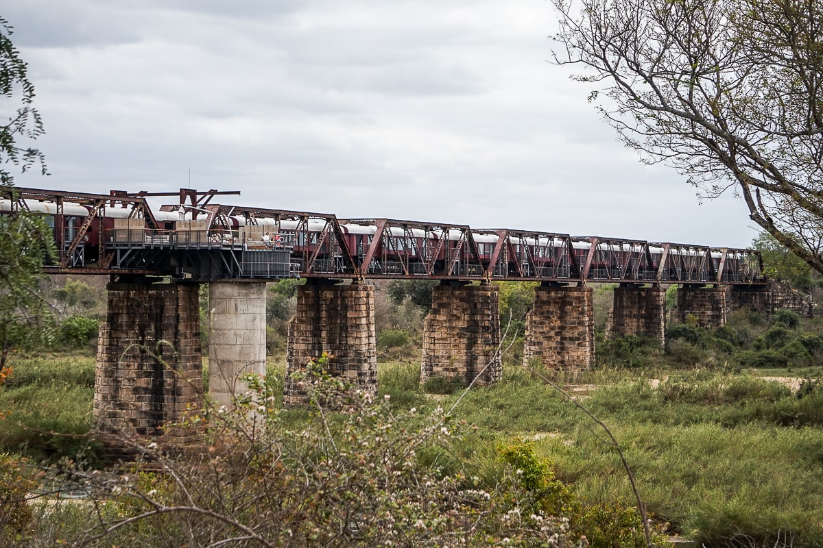 A disused viaduct bridge train track with a hotel on the train