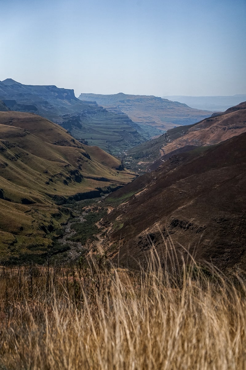 A road leading through the grassy mountains