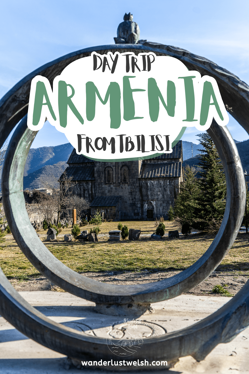 A monastery viewed through a decorative iron circle with the words "Armenia Day Trip from Tbilisi" superimposed