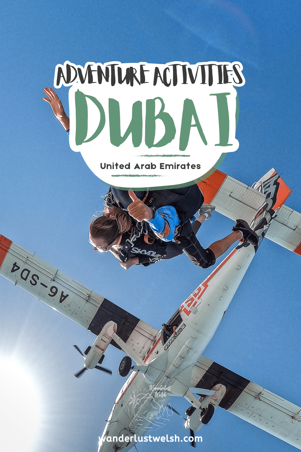 A woman and man tandem skydiving with a white and red plane above them with the words "Adventure activities Dubai" superimposed