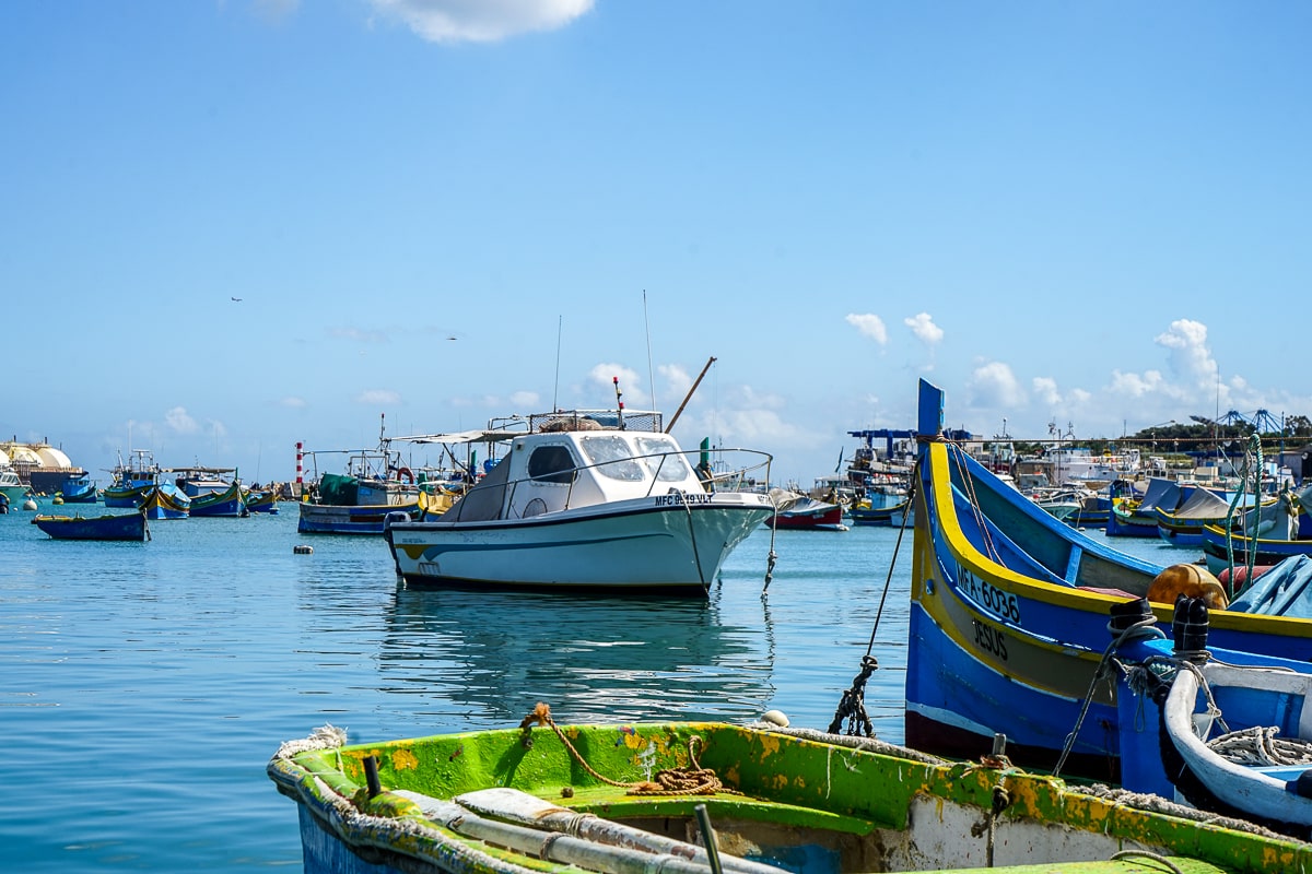 Many colorful fishing boats anchored and docked at the shore