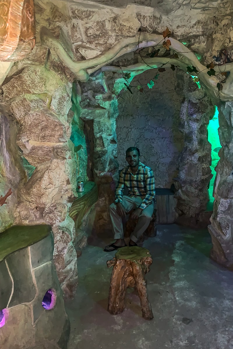A man in a bar carved out of a cave