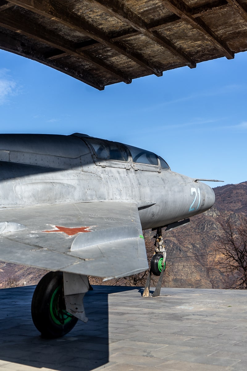 A full size model of a Mig-21 fighter jet in an open air museum