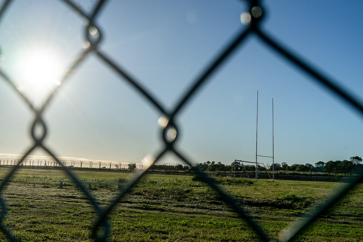 A rugby field behind a fence