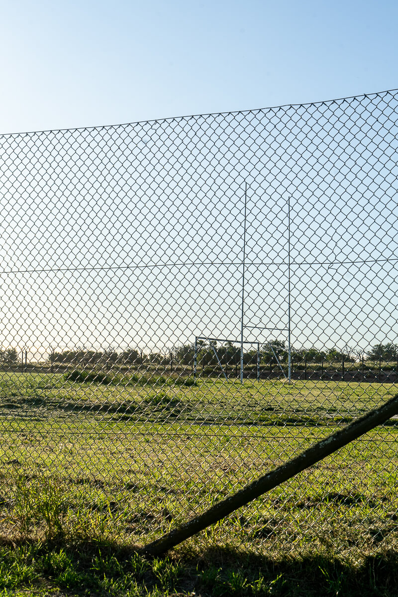 A rugby pitch behind a fence