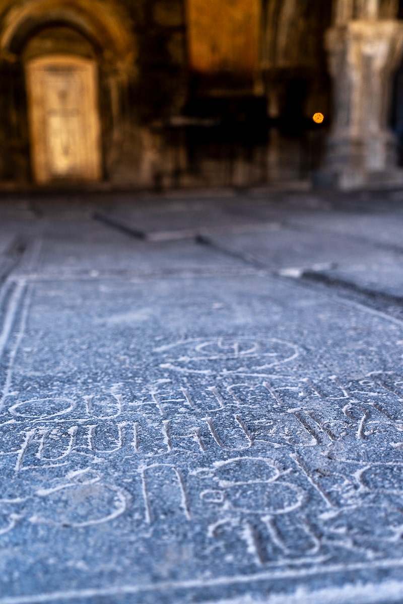 A closeup of an engraved floor with Armenian writings