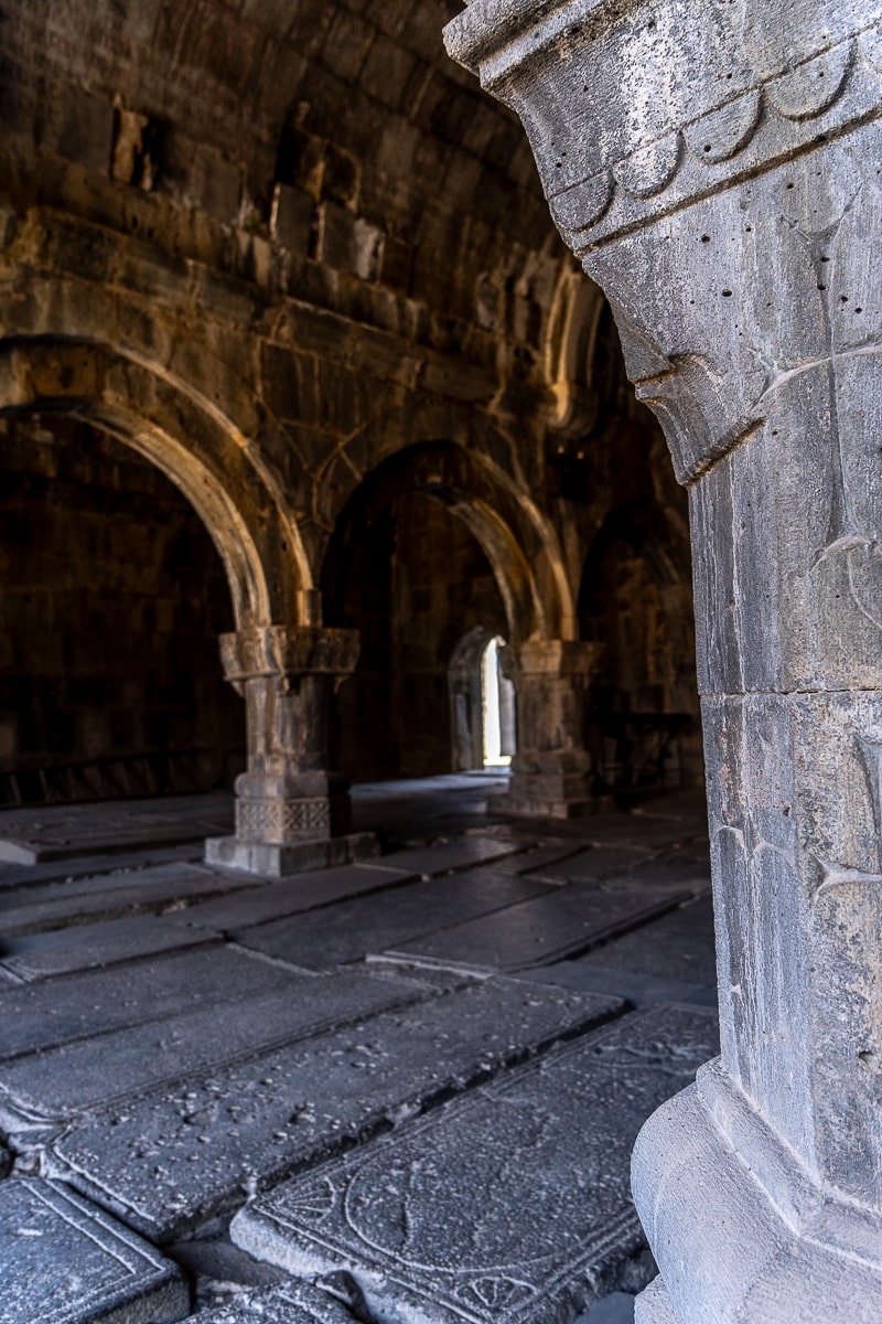 A room with an engraved stone floor and archways