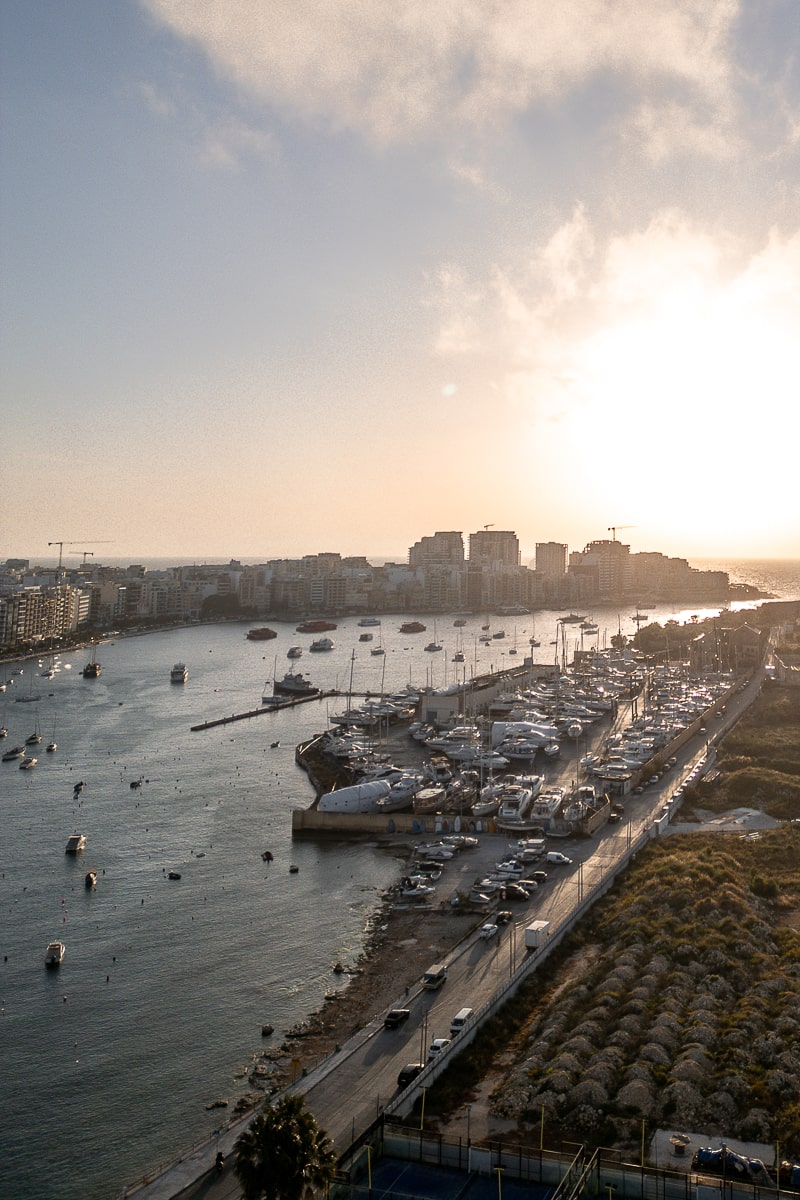 A sunrise over a marina of boats in Malta