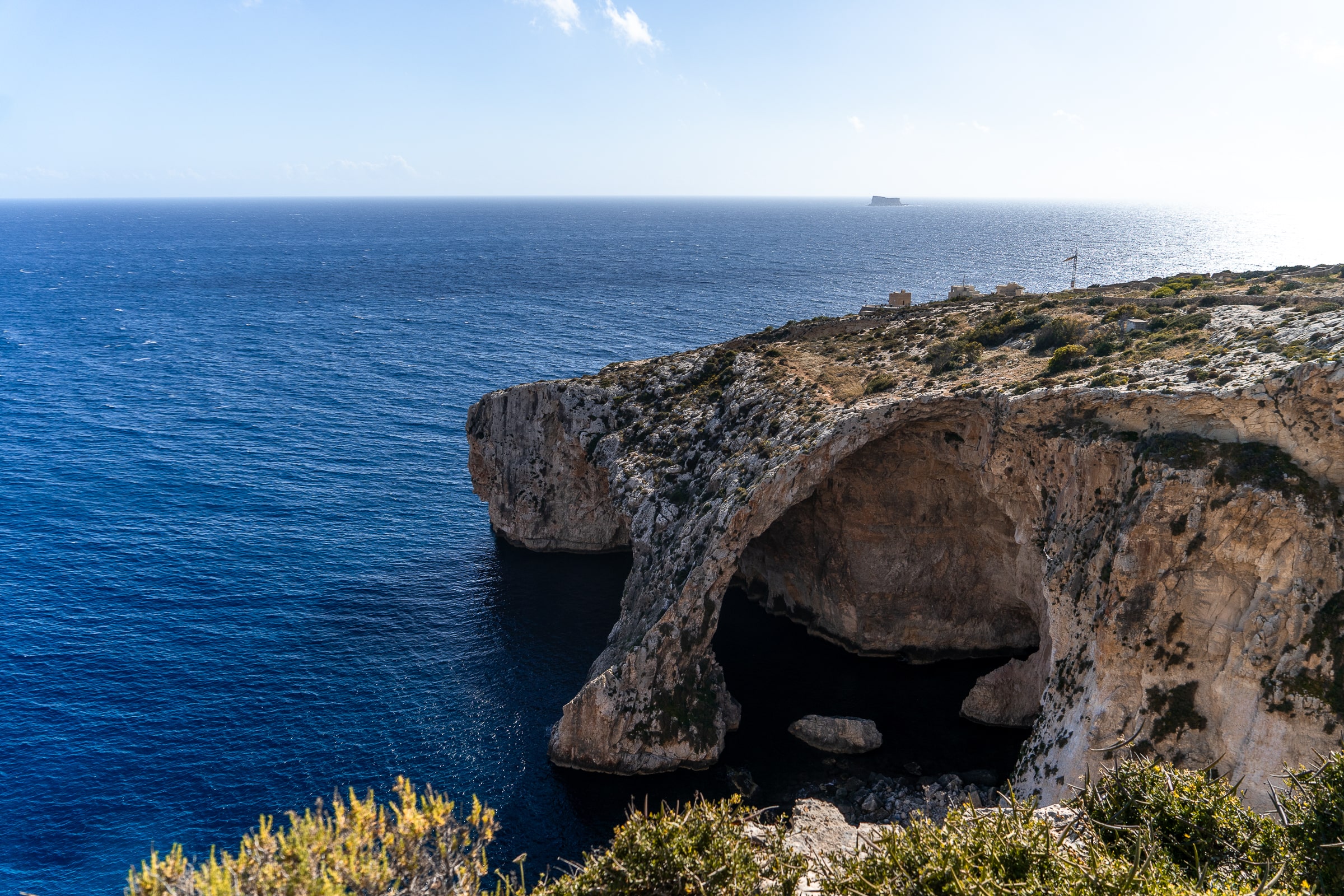 A natural rock arch over the blue sea