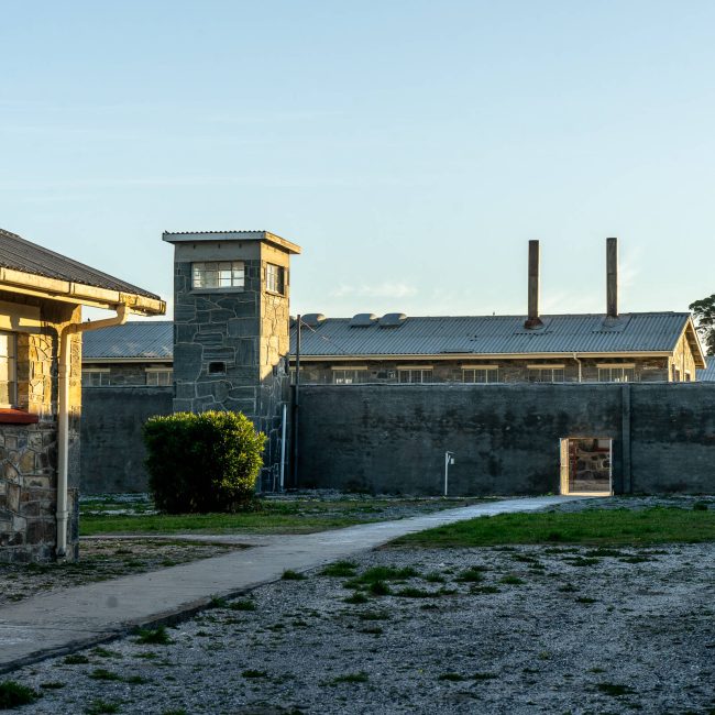 A yard, prison blocks, and guardtowers in Robben Island