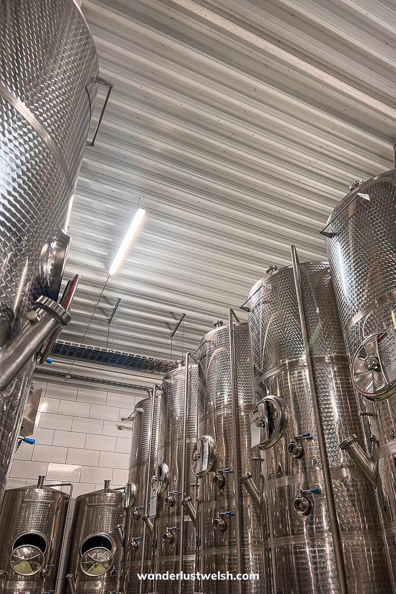 A set of metal wine vats in a factory