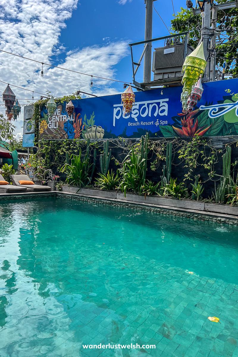 An outdoor pool with a living wall of plants