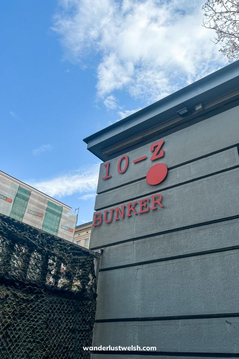 A grey concrete building with red lettering on the side reading "10-Z Bunker"