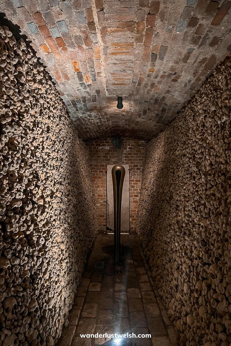 Inside Brno ossuary, walls of skulls on either side