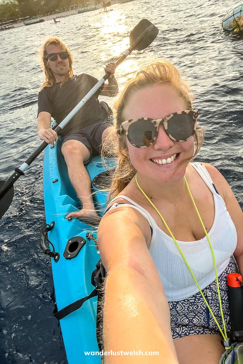 Selfie of a couple on a blue sea kayak