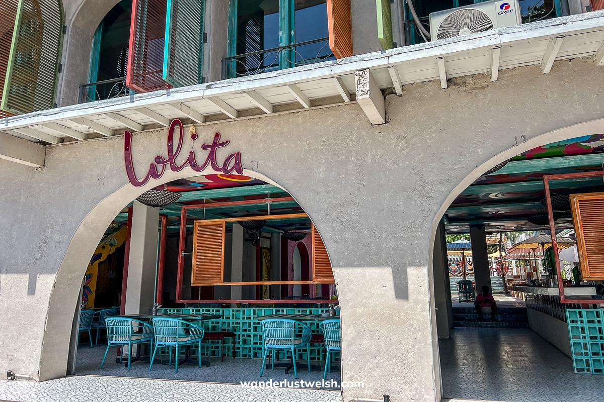 The front of "Lolita" restaurant with white walls and archways