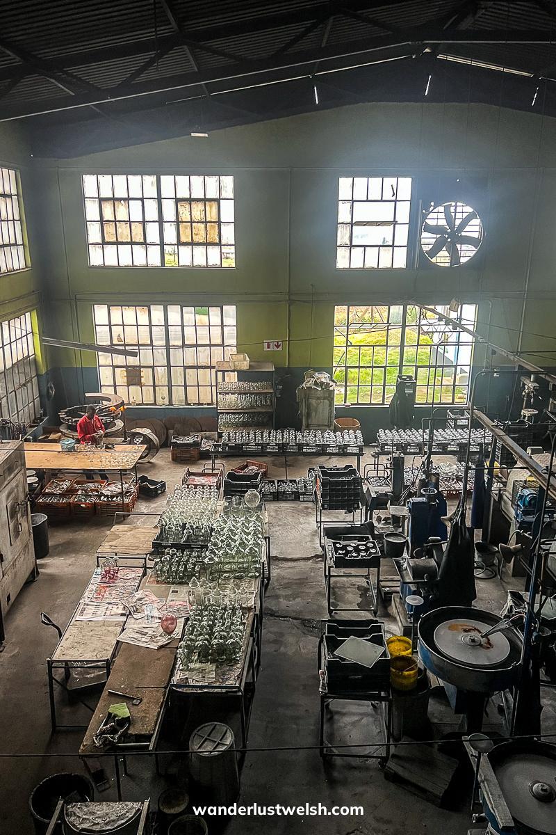 A glass factory with furnaces and blowing machines
