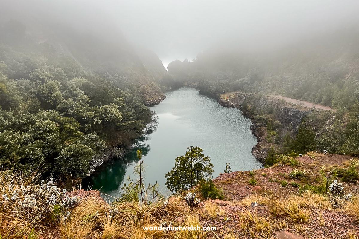 A man-made quarry filled with a lake