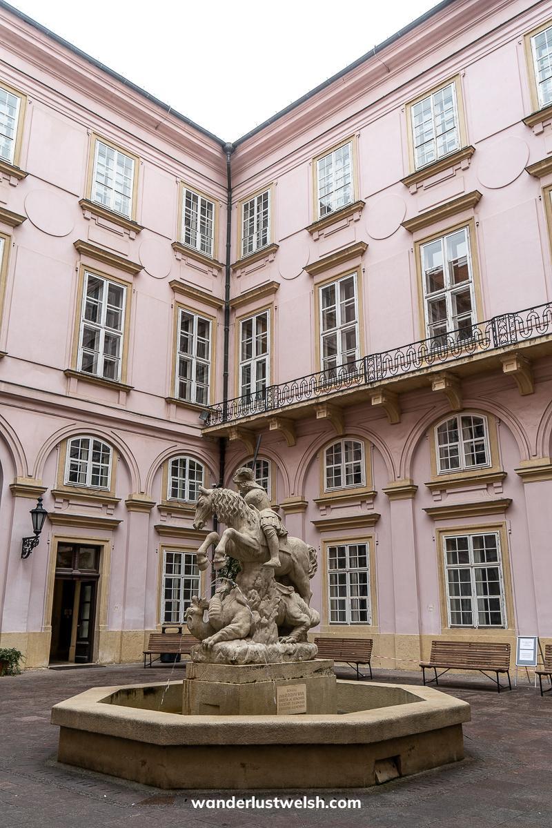 Courtyard of a pink palace with fountain