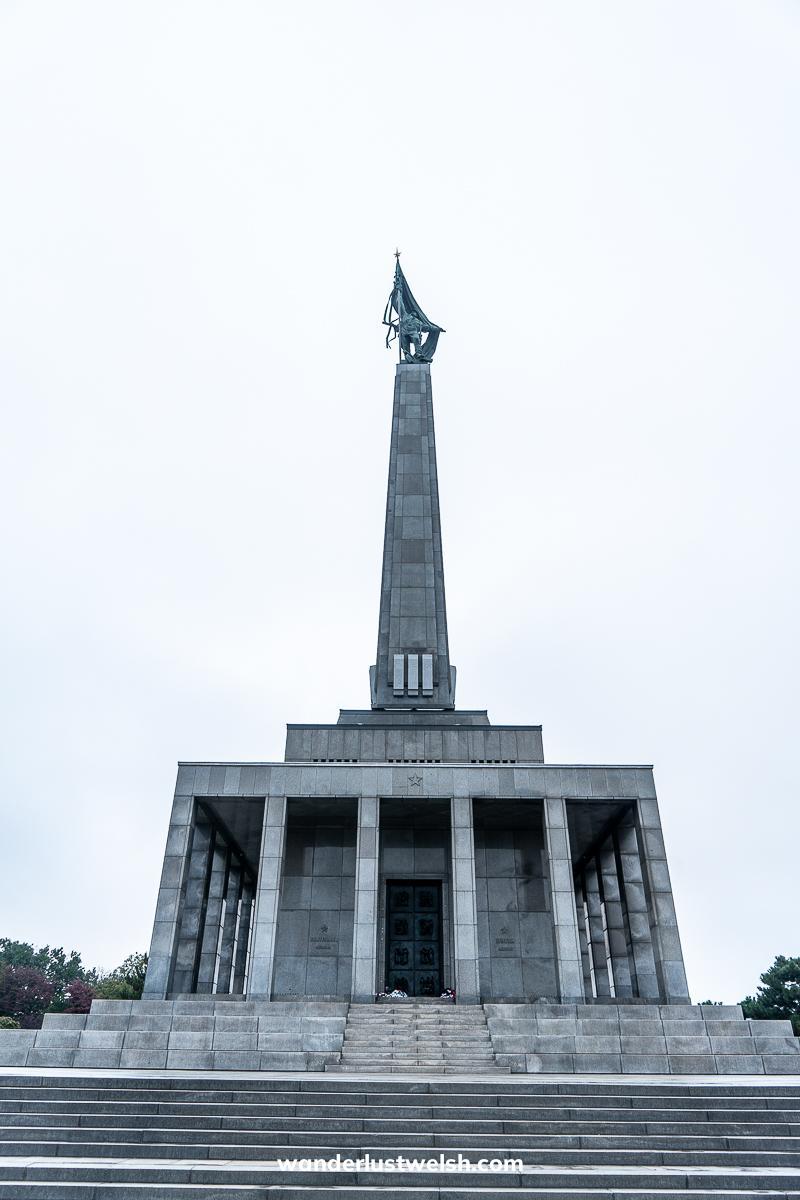 The Slavin War memorial - A pedestal building with obelisk above topped with a statue of a soldier raising a flag