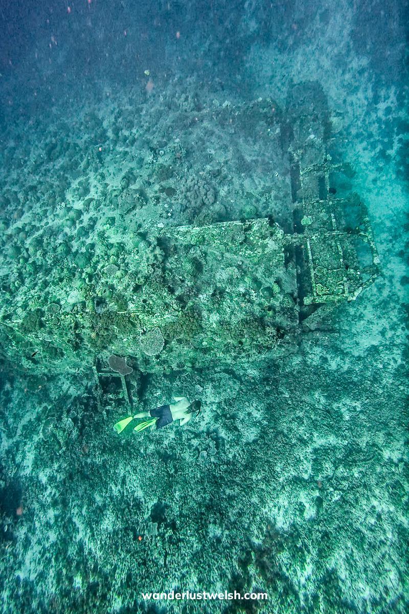 A man freediving deep to a shipwreck near Gili T