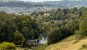 A view of Bath from Prior Park with a lake and Palladian Bridge in the foreground