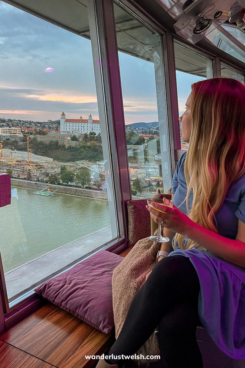 A woman looking out over Bratislava from the UFO tower