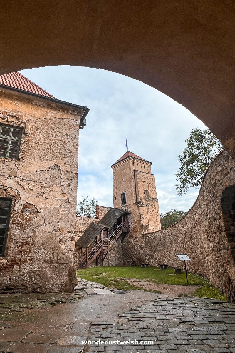 A castle courtyard viewed through an archway