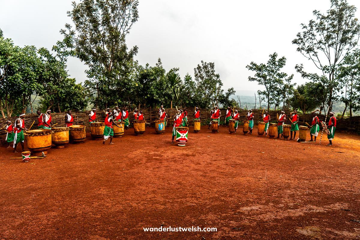 A group of drummers in outfits with Burundi's national colors of red, green, and white