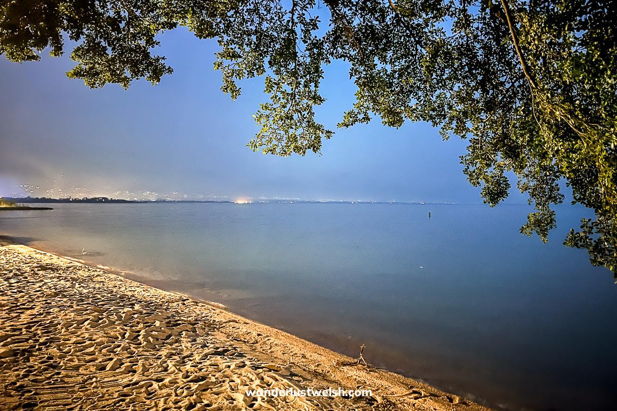 Lake Tanganyika in Bujumbura at dusk with overhanging trees
