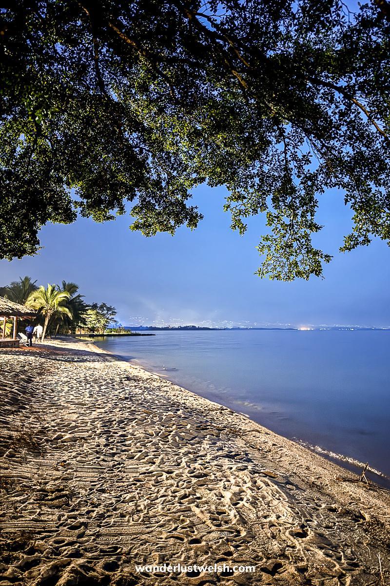 Lake Tanganyika in Bujumbura at dusk with trees overhanging