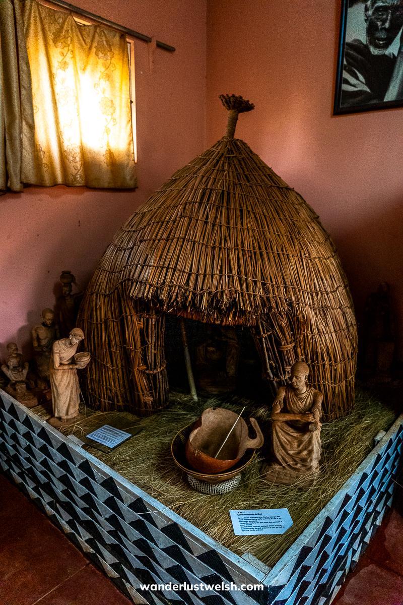 A model of a traditional Burundi house with man and woman