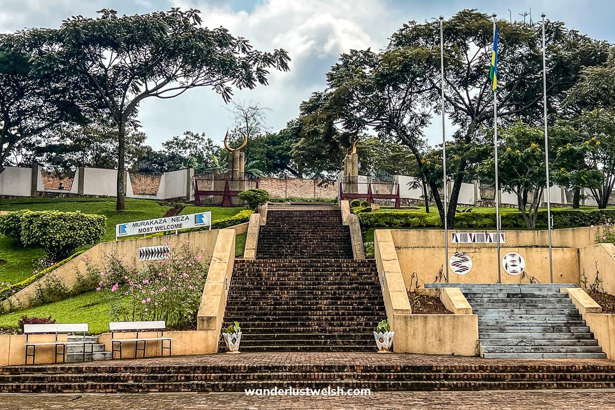 Steps leading to the Rwanda Ethnographic museum, with gardens, trees, and flagpoles